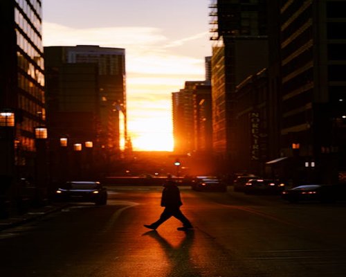 person walking home calmly during golden hour in the city